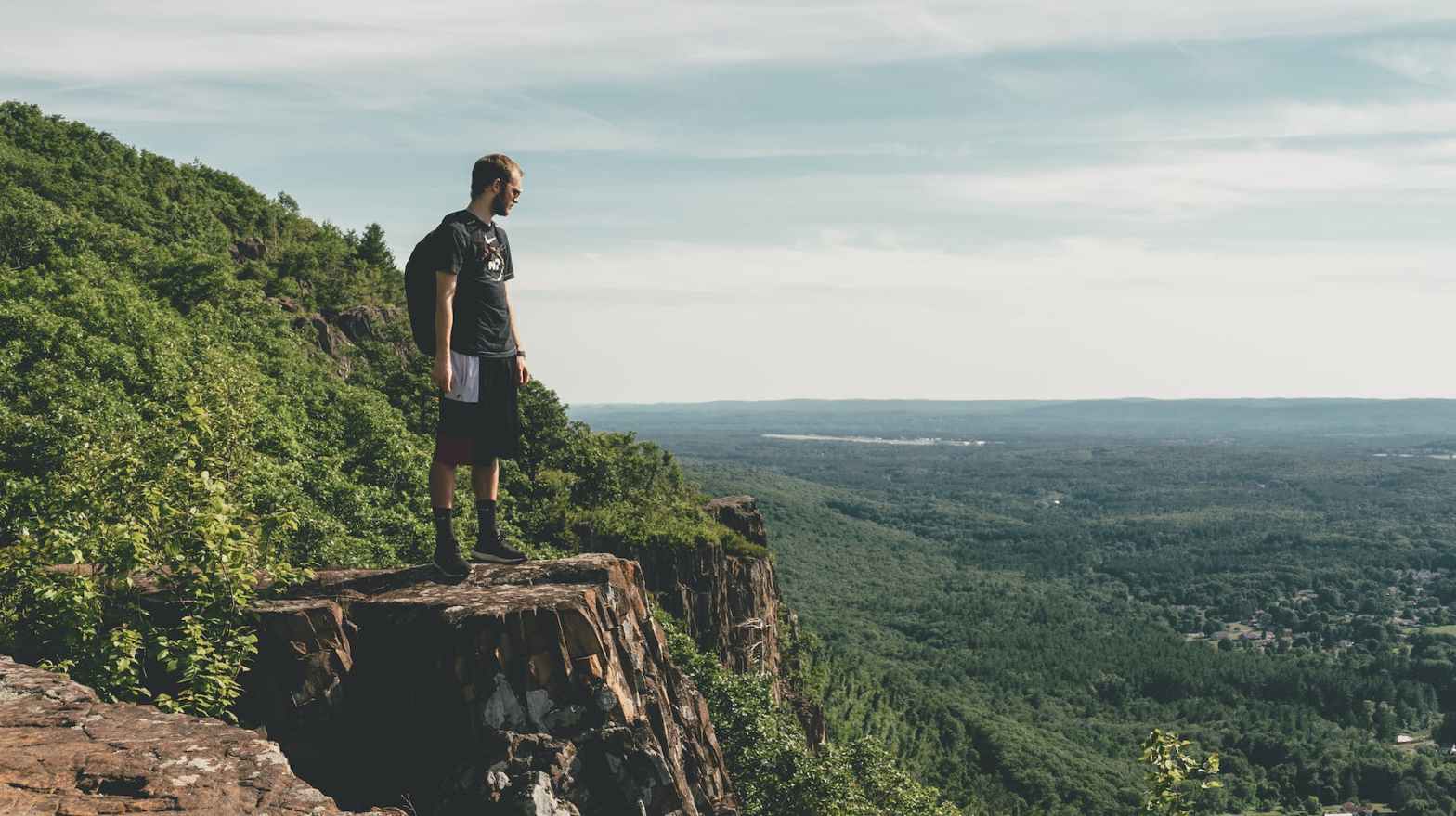 man standing on the cliff