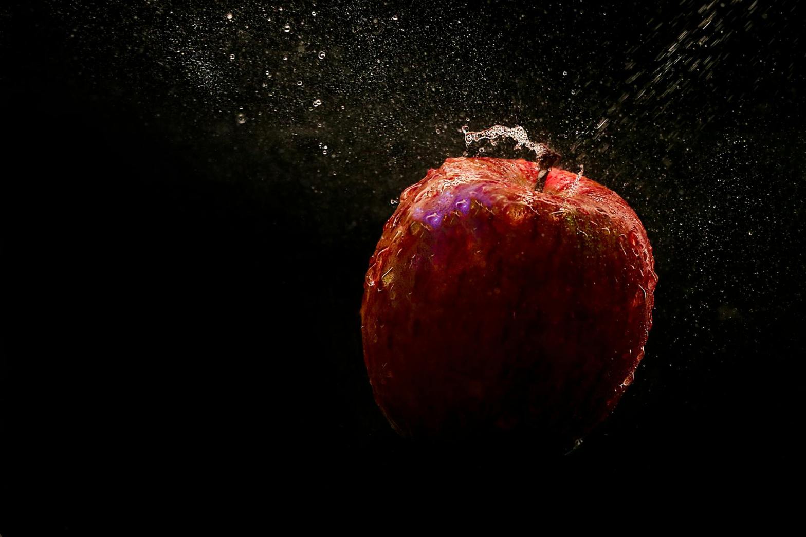 time lapse photography of falling red apple